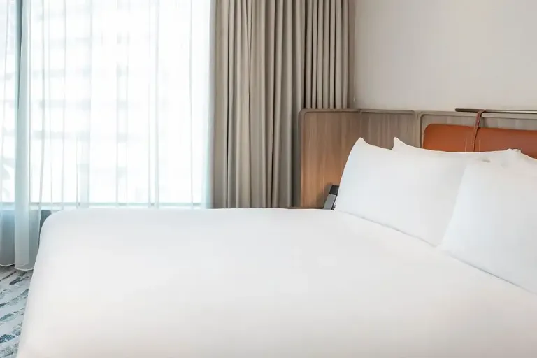 Queen size bed in Premier Causeway Bay City View Room at Dorsett Wanchai
