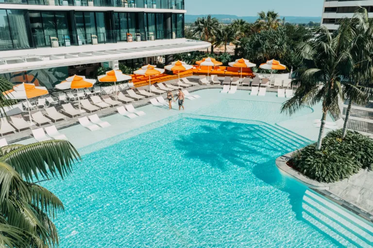 Sunbeds by the outdoor pool at Dorsett Gold Coast