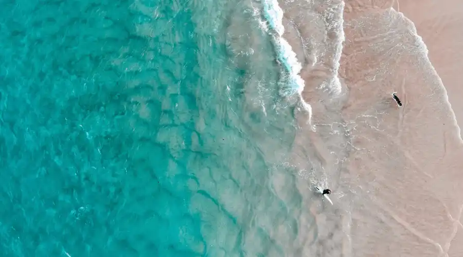 People surfing in clear waters on Main Beach QLD