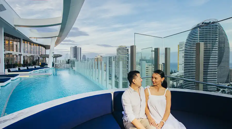 couple sat by rooftop pool ay Nineteen Star Casino