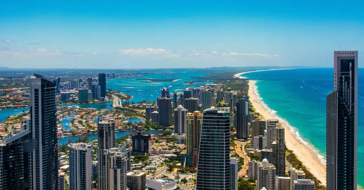 Aerial view of the Gold Coast city skyline, beaches, and canals on a blue sky day