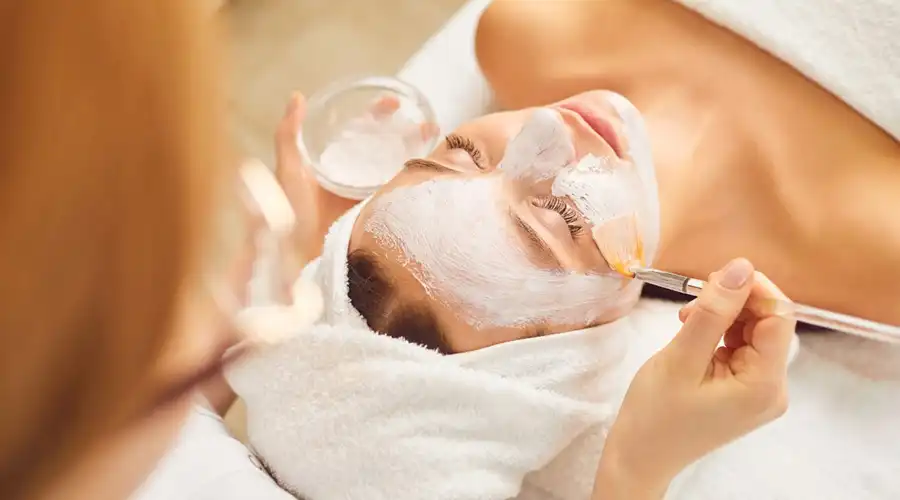 A woman getting a facial at a spa