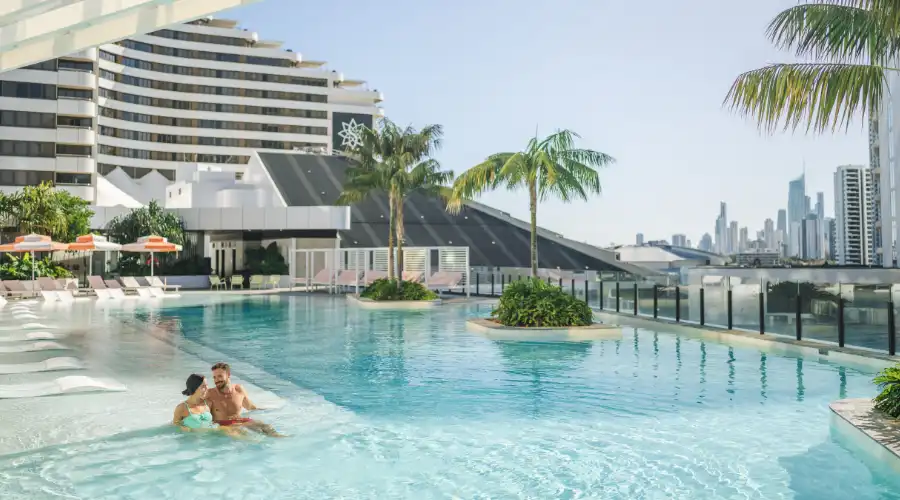 A couple in the rooftop infinity pool at Dorsett Gold Coast