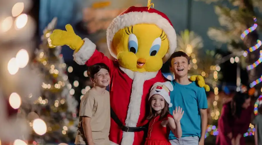 Kids with a character at Movie World's White Christmas parade