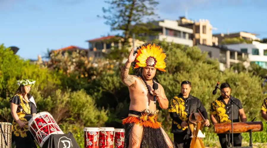 Man in traditional costume dancing to drums