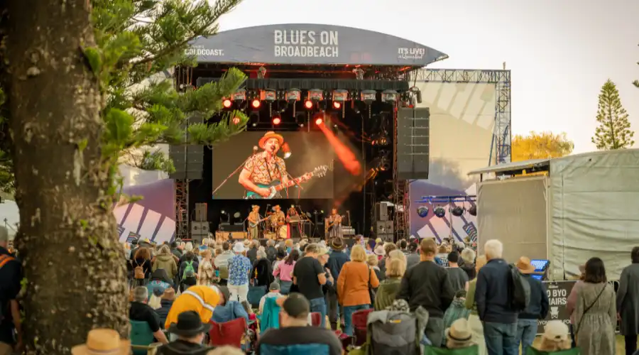 Blues concert with crowd watching man with guitar on stage