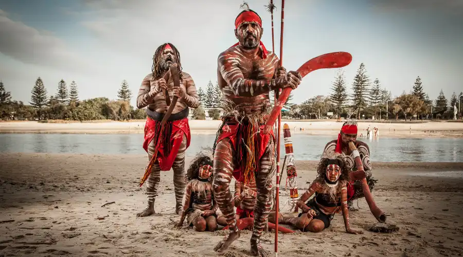 Luther Cora and a group of Aboriginal performers on the sand at Tallebudgera Creek