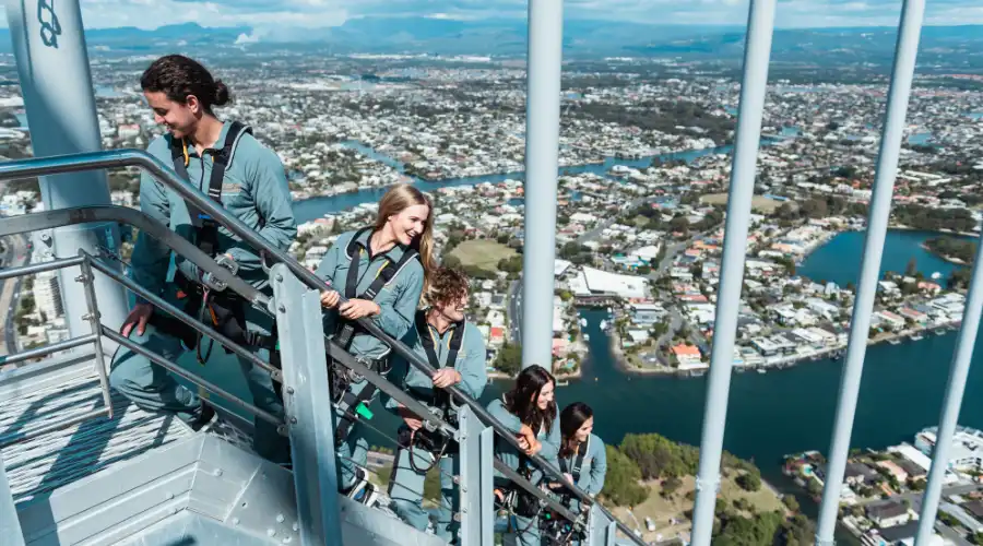 A group enjoying the Skypoint climb with views of canals and Hinterland as a backdrop