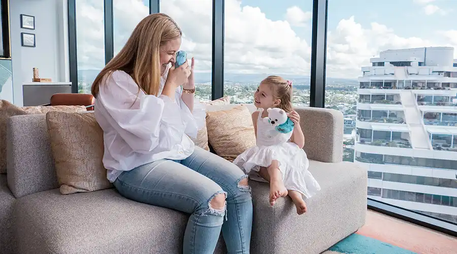 Mother and daughter sitting on lounge