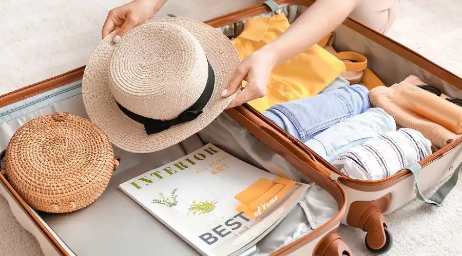 An open suitcase being packed for a beach holiday