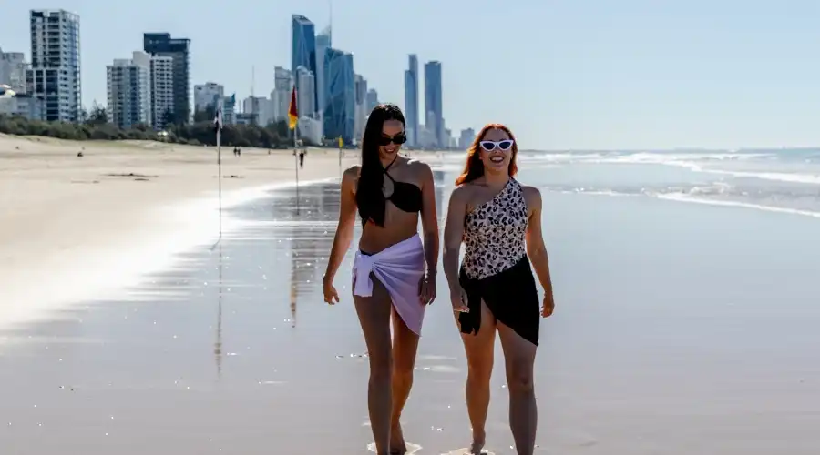 Two women walking along the beach at Broadbeach