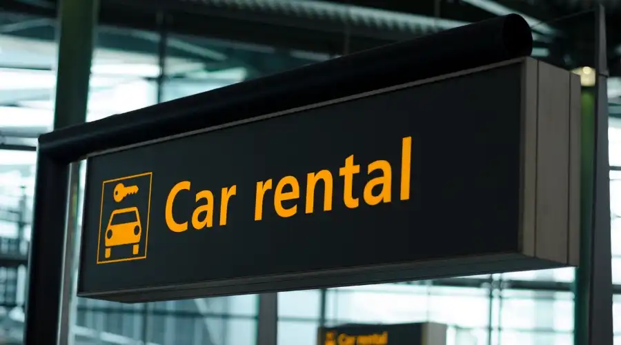 Airport directions sign pointing to car rentals