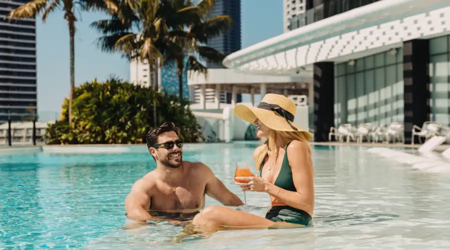 Couple relaxing in the pool at Dorsett Gold Coast