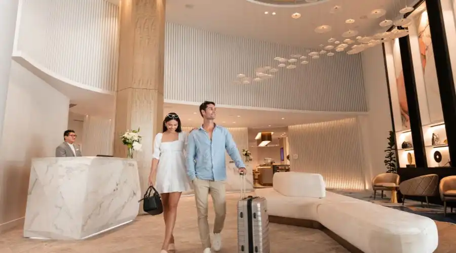 Couple walking through hotel lobby Couple walking through hotel lobby