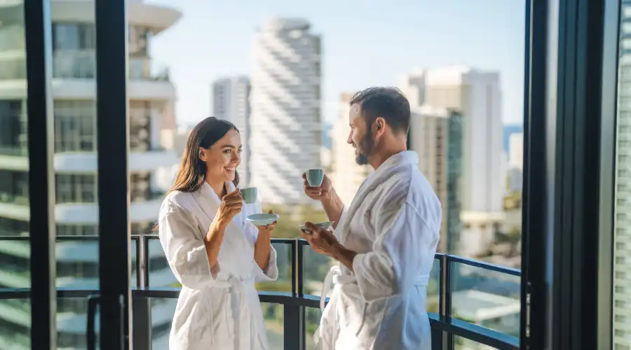 Couple relaxing on the balcony of an Executive King Panoramic Room at the Dorsett Gold Coast
