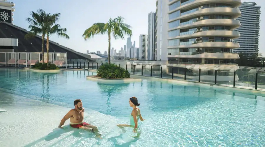 Couple relaxing at the Isoletto Pool Club at the Dorsett Gold Coast