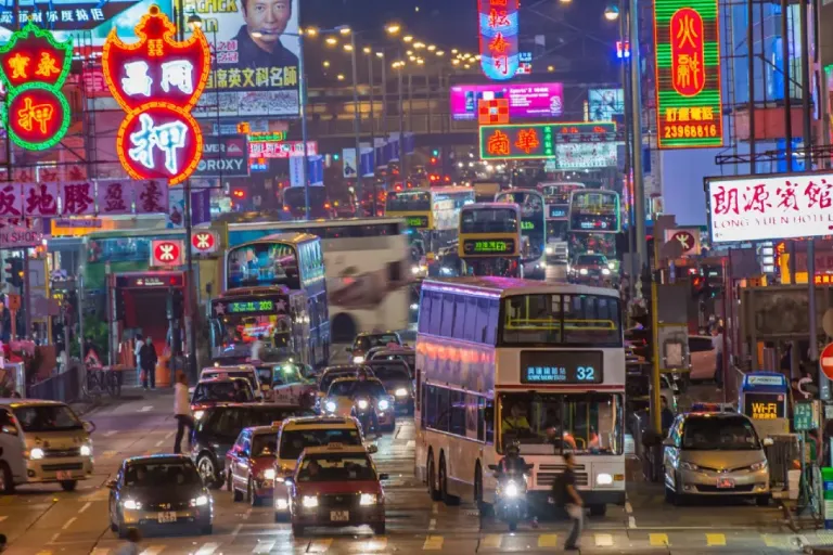 A vibrant street in Hong Kong with neon light signs
