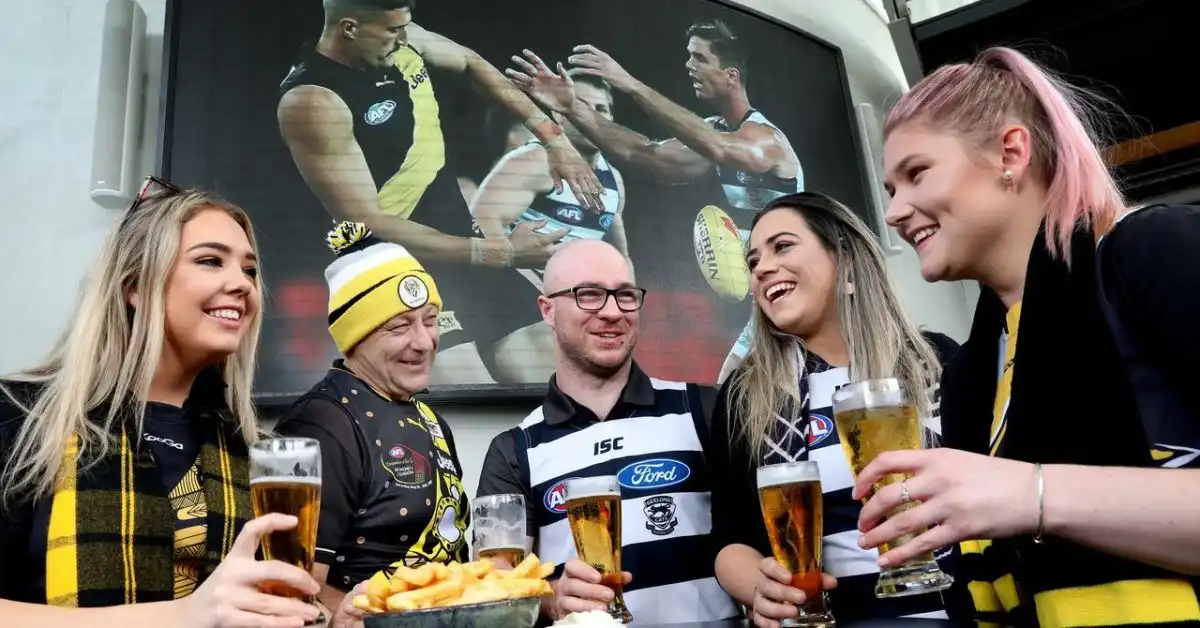 AFL fans gather at a pub for beers and food to celebrate the Grand Final