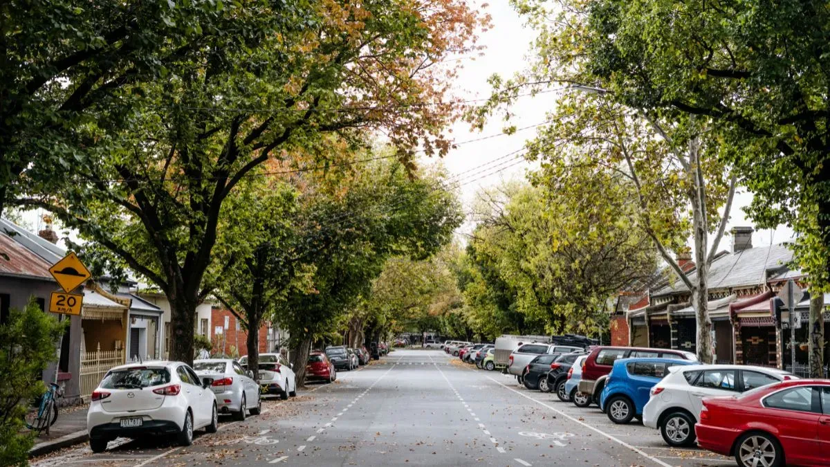 Tree-lined Fitzroy street in Melbourne with autumn foliage