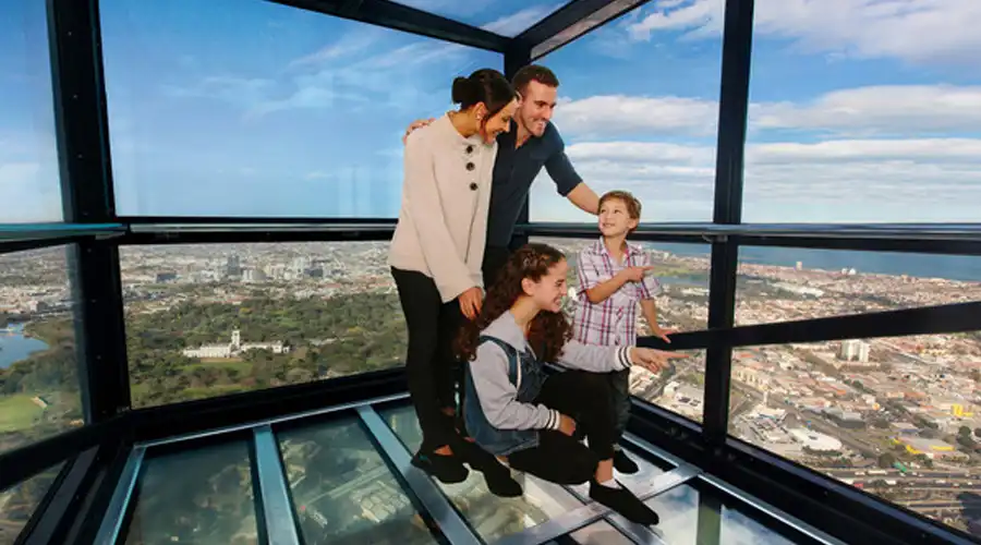Family enjoying the view from Melbourne Skydeck, Melbourne&rsquo;s highest public viewing platform, with panoramic vistas of the city skyline and beyond, including scenic landscapes.