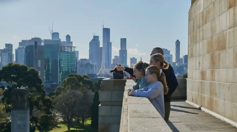 Family of four enjoying Melbourne city views from the Shrine of Remembrance