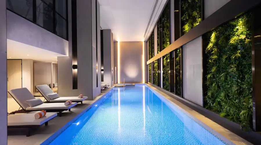  Indoor pool with ambient lighting and vertical gardens at Dorsett Melbourne