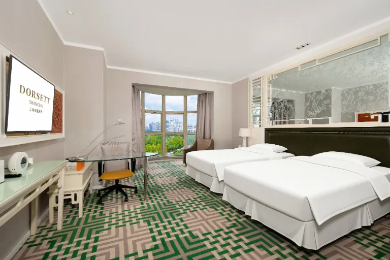 Bed, TV and desk in the Dorsett Shanghai Deluxe Studio Room.