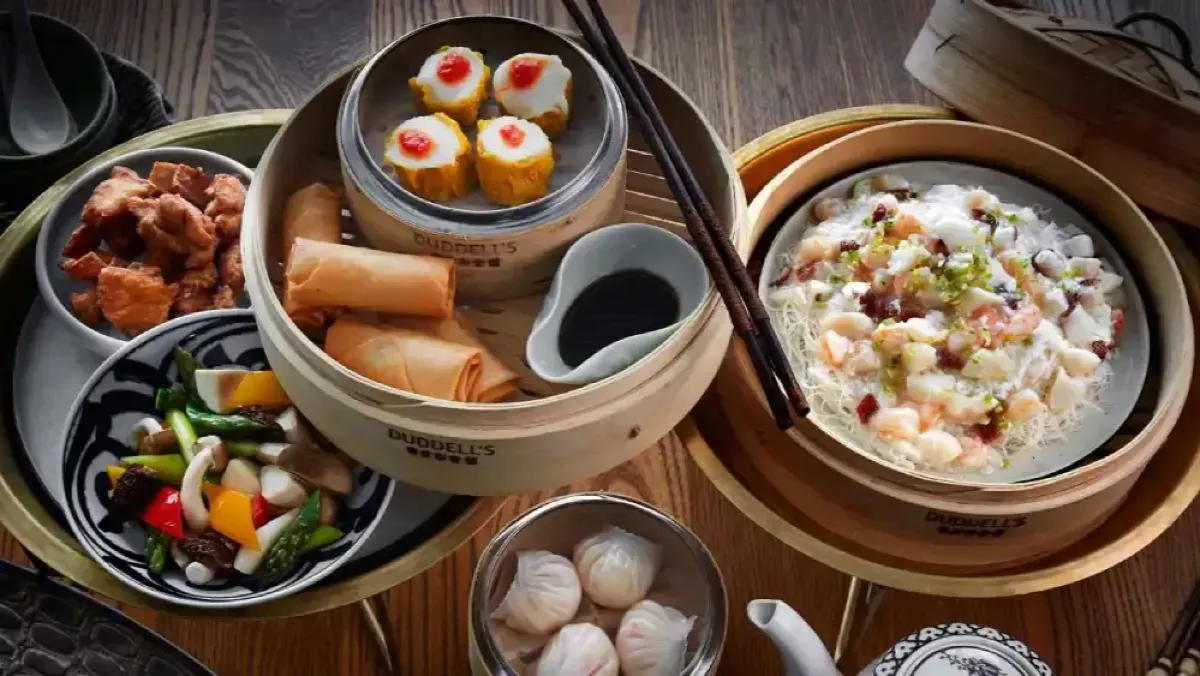 Cantonese dim sum dishes including siu mai, spring rolls and dumplings served in bamboo steamers