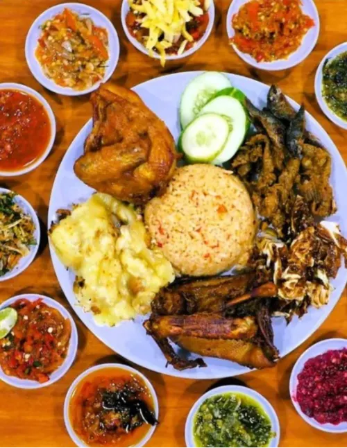 A platter featuring popular Chinese dim sum and breakfast foods like fried dough sticks, wrapped sticky rice and steamed pork buns.