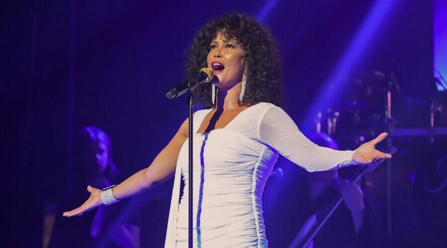 Performer singing Whitney Houston tributes on stage