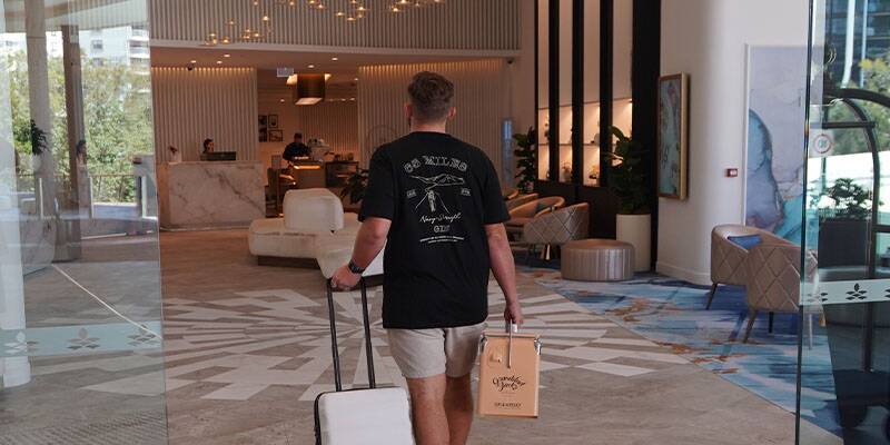 Man with suitcase walking into hotel