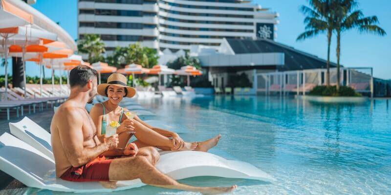 couple on pool loungers at Dorsett Gold Coast