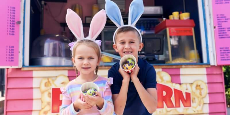 Two children holding Easter eggs at Luna Park