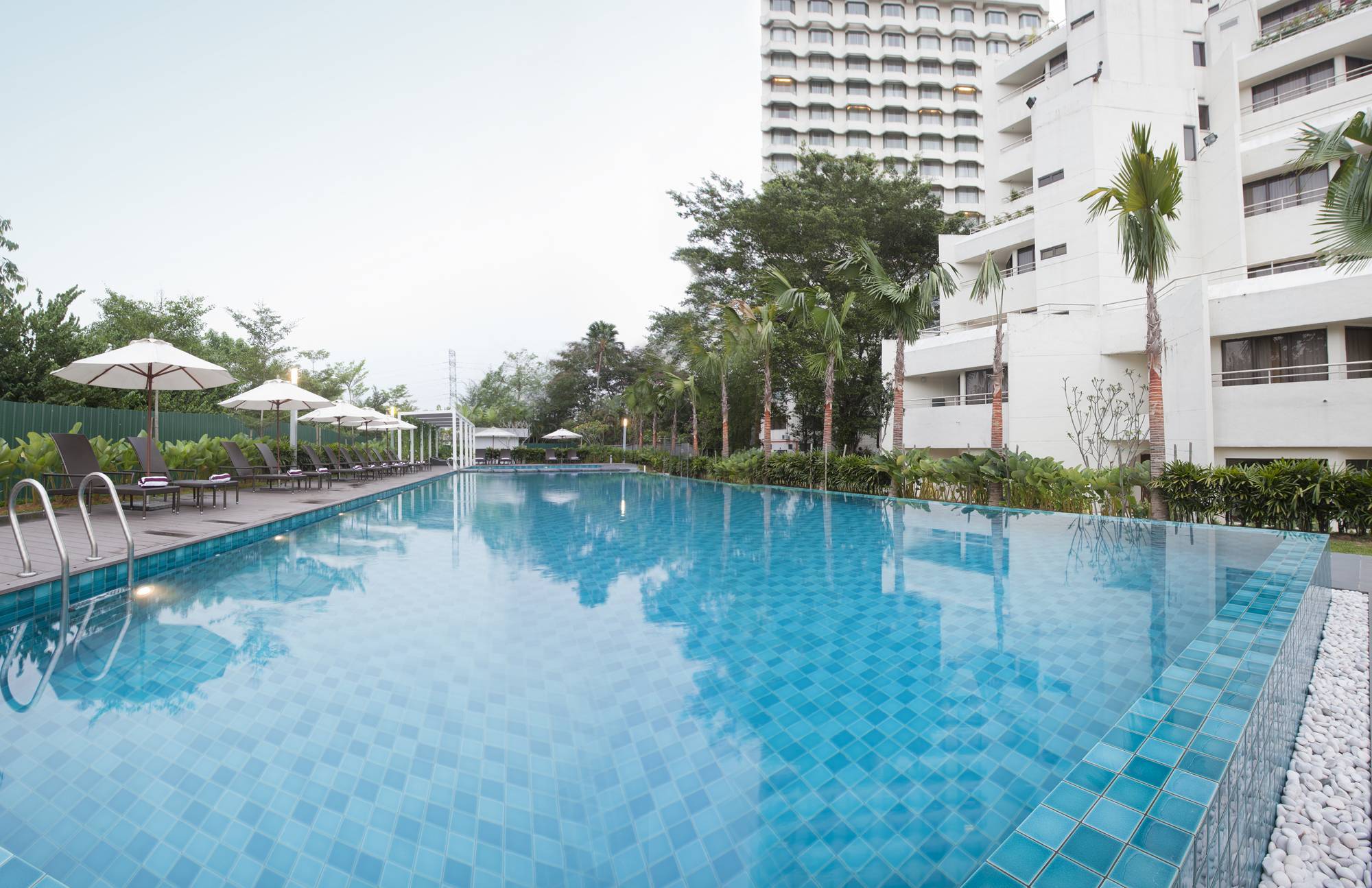 The outdoor sparkling pool, offering an inviting respite from the day's heat