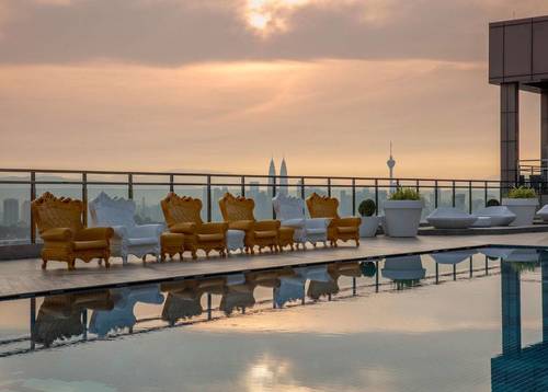 As the sun sets, the evening view at the rooftop pool is beyond spectacular